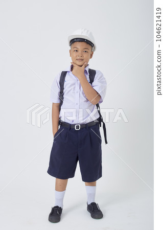 A young Asian cute boy standing in a Thai school uniform with a backpack bag and safety helmet on a white background banner A young Asian cute boy standing in a Thai school uniform with a backpack bag and safety helmet on a white background banner 104621419