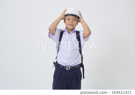 A young Asian cute boy standing in a Thai school uniform with a backpack bag and safety helmet  on a white background banner 104621421