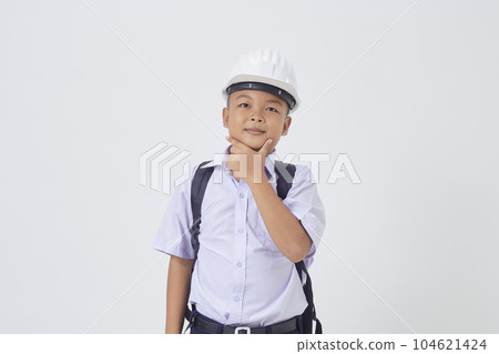 A young Asian cute boy standing in a Thai school uniform with a backpack bag and safety helmet  on a white background banner 104621424