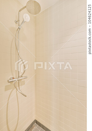 a shower with white tiles on the walls and gray gre tile flooring in a bathroom area is shown 104624125
