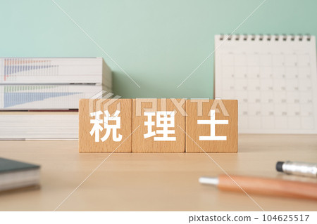 A desk with a block written as a tax accountant A desk with a block written as a tax accountant 104625517