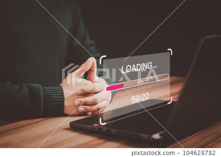 Young user using a laptop computer for download and update software with waiting to loading digital file data form website, very slow internet form wifi. Concept of waiting for load of loading symbol. 104628782