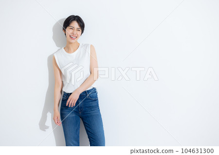 Woman in white sleeveless and denim 104631300
