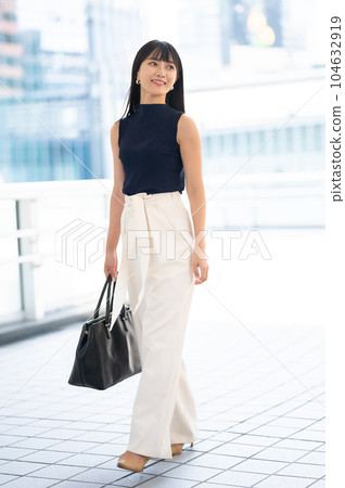 sleeveless woman walking 104632919