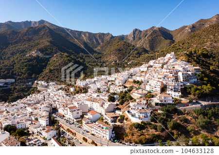 Aerial view of Ojen, white village over a hillside near Marbella, Spain in the spring Aerial view of Ojen, white village over a hillside near Marbella, Spain in the spring 104633128