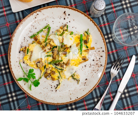 Tasty scrambled eggs with asparagus and mushrooms Tasty scrambled eggs with asparagus and mushrooms 104633207