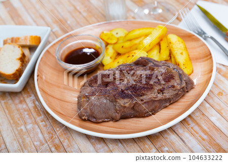 Fried beef fillet with potatoes and sauce Fried beef fillet with potatoes and sauce 104633222