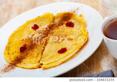 Crepes with cocoa and confiture for breakfast Crepes with cocoa and confiture for breakfast 104633234