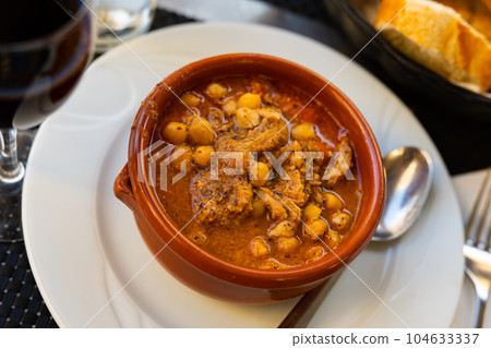 Stew with tripe, chickpea, chorizo and bacon in sauce Stew with tripe, chickpea, chorizo and bacon in sauce 104633337