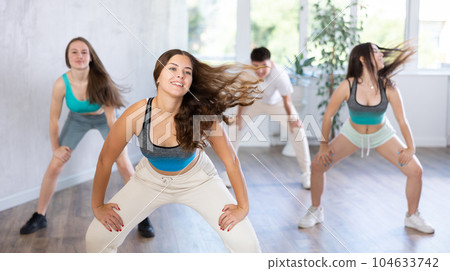 Group of young women and young guy dancing hip hop Group of young women and young guy dancing hip hop 104633742