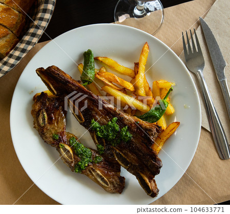 Spanish dish is Churasco, made from roast beef. Served with French fries and stewed peppers Spanish dish is Churasco, made from roast beef. Served with French fries and stewed peppers 104633771