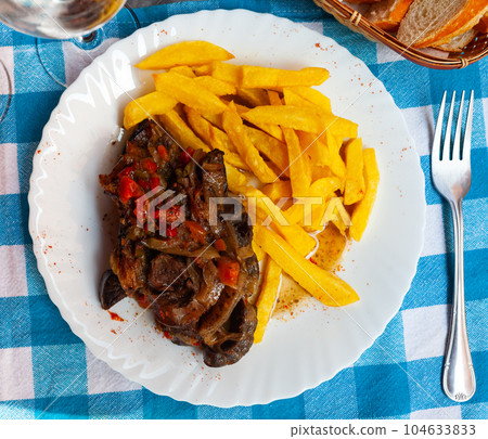Beef steak Ossobuco with fried potatoes 104633833