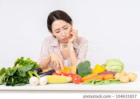 Middle-aged woman worried about vegetables Middle-aged woman worried about vegetables 104633857