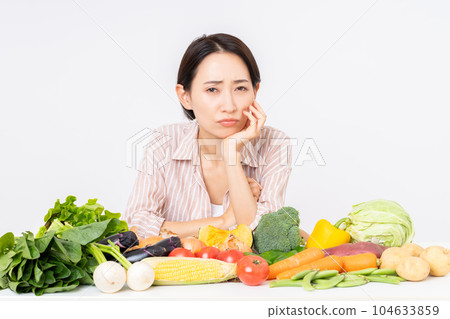 Middle-aged woman worried about vegetables Middle-aged woman worried about vegetables 104633859