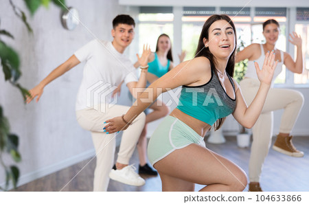 Girl teen perform choreographic exercise and teach energetic waacking dance with friends 104633866