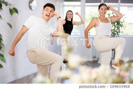 Group of young women and young guy dancing jazz funk Group of young women and young guy dancing jazz funk 104633908