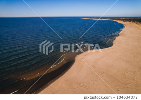 Drone aerial view of waves sea ocean coast. Beach and dunes dark calm sea waves nature landscape captured with drone. Tourism 104634072