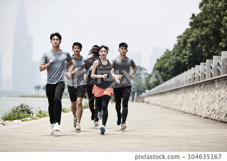 group of five young asian adult men and woman running training outdoors group of five young asian adult men and woman running training outdoors 104635167