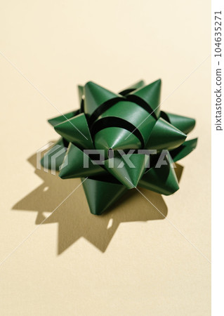 Photo of a gift bow on a beige background. 104635271