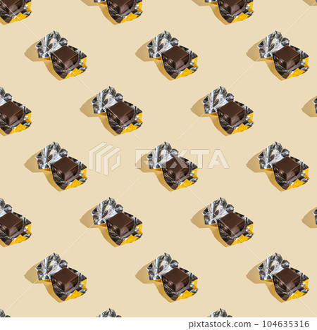 Beautiful chocolate wrapped pattern on beige background. 104635316