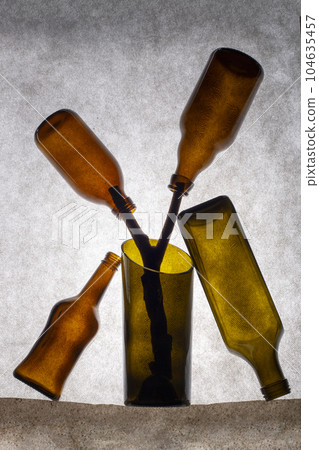 Still life with a figure of colored bottles 104635457