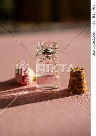 A bottle of cosmetic gel on a pink background. 104635468