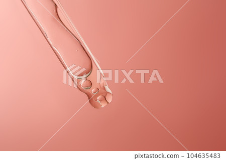 Pipette with cosmetic product in water with bubbles. 104635483