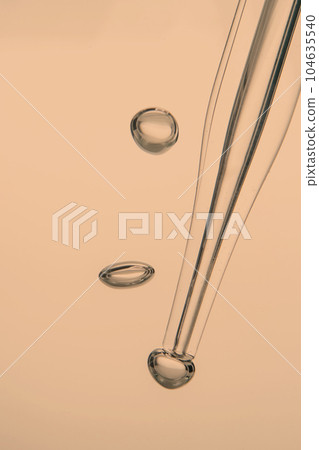 Pipette with cosmetic product in water with bubbles. 104635540