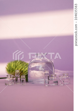 Beautiful abstract background with glass containers on a purple background. 104635563