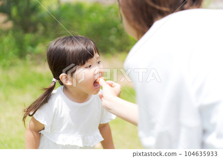 A child who harvests and eats mini tomatoes A child who harvests and eats mini tomatoes 104635933