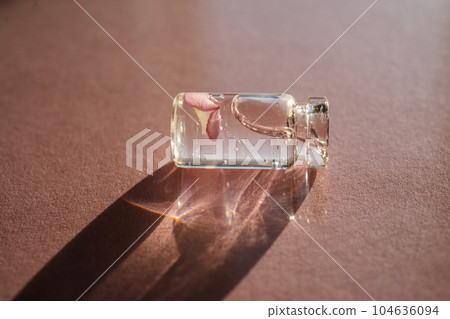 A bottle of cosmetic gel on a pink background. 104636094