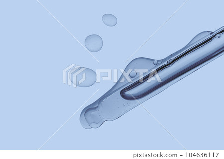 Pipette with cosmetic product in water with bubbles. 104636117