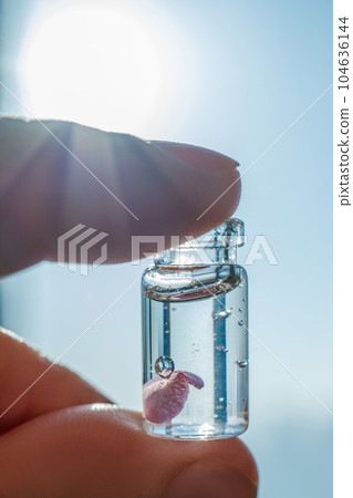 A bottle of cosmetic gel on a sky background. 104636144