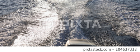 Outboard motor wake from cruising powerboat on sea Outboard motor wake from cruising powerboat on sea 104637338