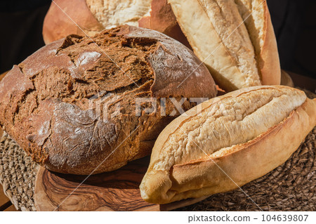 Traditional pastries in Turkey, fresh bread on the bakery counter. Natural lighting, delicious pastries on the table, close-up, selective focus. Homemade whole grain bread 104639807