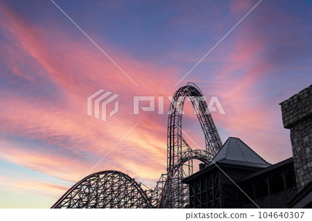 Riding the roller coaster at Energylandia Zator Poland amusement park. Solar powered roller coaster. Rollercoaster against blue sky Wooden outdoor leisure family Riding the roller coaster at Energylandia Zator Poland amusement park. Solar powered roller coaster. Rollercoaster against blue sky Wooden outdoor leisure family 104640307