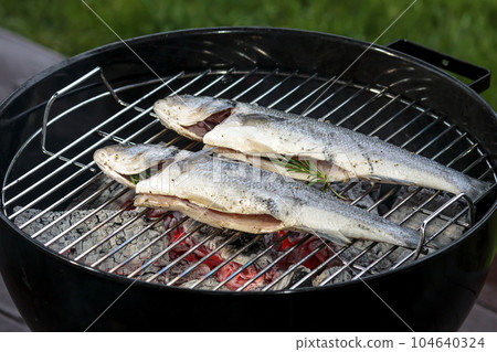 Fresh grilled fish barbeque, whole roasted bass 104640324