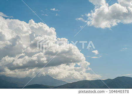 Beautiful view of the mountains and cumulus clouds on the Aegean Sea, travel time, postcard for background or screensaver Beautiful view of the mountains and cumulus clouds on the Aegean Sea, travel time, postcard for background or screensaver 104640378