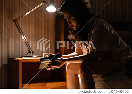 Depressed asian woman have no money,sitting alone in bedroom,opening empty wallet,anxious about her debts,insomnia illness,disease of anxiety,sickness of acute stress disorder from financial problems Depressed asian woman have no money,sitting alone in bedroom,opening empty wallet,anxious about her debts,insomnia illness,disease of anxiety,sickness of acute stress disorder from financial problems 104640692