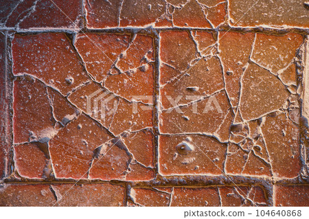 Old stone tiles on the floor of the castle, cracked terracotta tiles, idea for a background or screensaver, destruction and use of natural materials Old stone tiles on the floor of the castle, cracked terracotta tiles, idea for a background or screensaver, destruction and use of natural materials 104640868