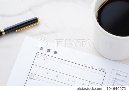Writing a resume while drinking coffee Writing a resume while drinking coffee 104640973
