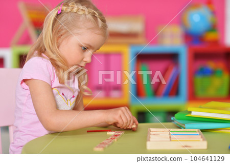 Little cute girl studying at the table at home 104641129
