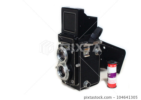 Antique twin-lens reflex camera and film white background 104641305