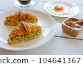 Croissant sandwich with egg,avocado on white dish and honey, coffee. breakfast and healthy food concept.. 104641367