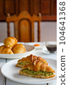 Croissant sandwich with egg,avocado on white dish and honey, coffee. breakfast and healthy food concept.. 104641368