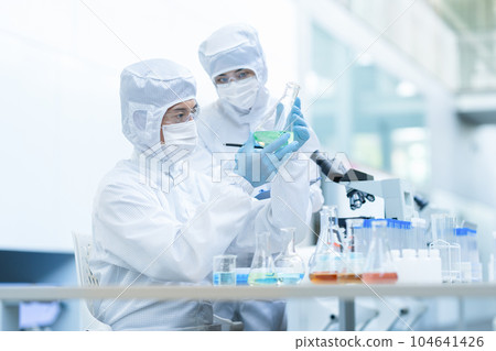 A researcher conducting an experiment in a clean room 104641426