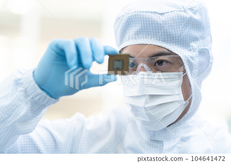 Engineer inspecting CPU in clean room Engineer inspecting CPU in clean room 104641472