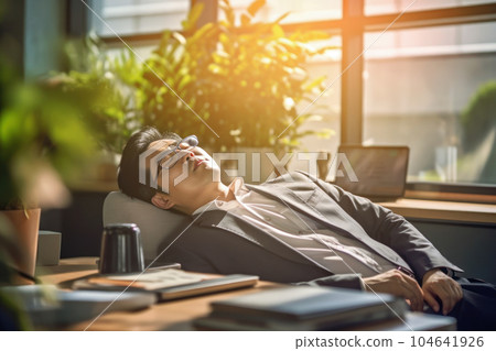 Businessman taking a nap at the company desk Businessman taking a nap at the company desk 104641926