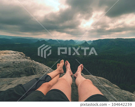 Tired hikers legs without shoes in mountains. Barefoot legs Tired hikers legs without shoes in mountains. Barefoot legs 104642239