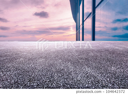 Asphalt road and city skyline of modern city at sunset 104642372